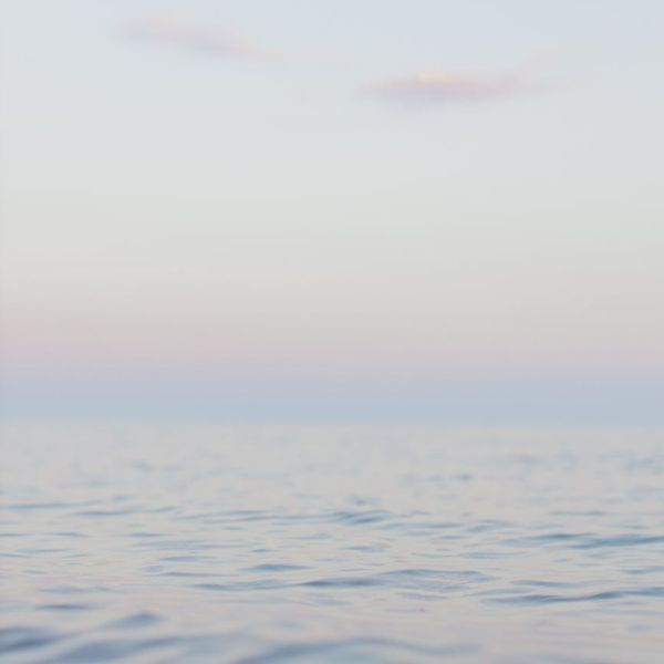 Man stretching outdoors with a serene landscape background.